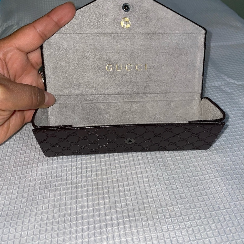 brown leather monogrammed foldable eyeglasses case from Gucci.